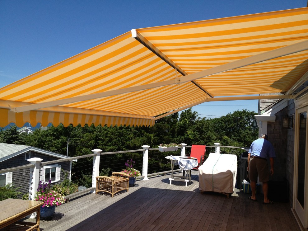 Inspiration for a mid-sized backyard patio in Boston with decking and an awning.