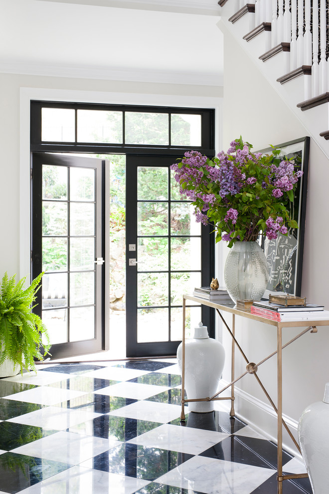 Example of a transitional marble floor and multicolored floor foyer design in DC Metro with white walls