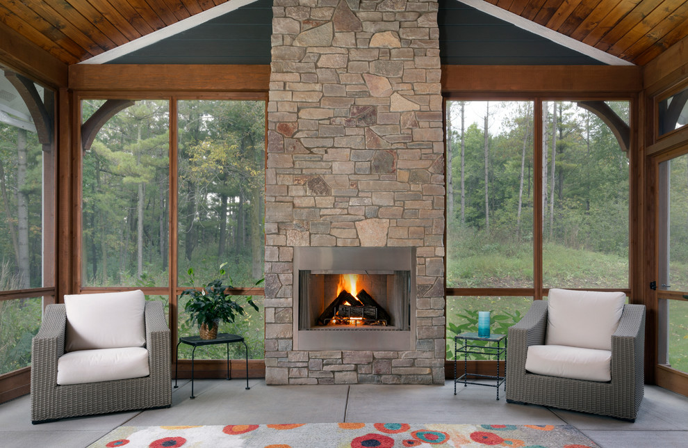 Inspiration for a large arts and crafts sunroom in Milwaukee with a stone fireplace surround, concrete floors and grey floor.