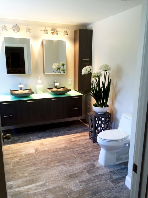 Photo of a mid-sized master bathroom in Miami with flat-panel cabinets, dark wood cabinets, a hot tub, an open shower, a one-piece toilet, brown tile, a pedestal sink and glass benchtops.