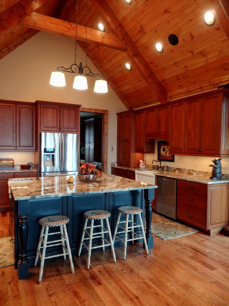 Large mountain style u-shaped light wood floor eat-in kitchen photo in Charlotte with a farmhouse sink, raised-panel cabinets, dark wood cabinets, granite countertops, beige backsplash, stainless steel appliances and an island