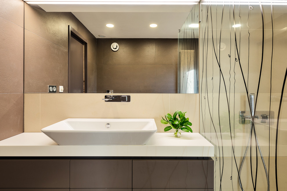 Inspiration for a small contemporary 3/4 bathroom in Other with furniture-like cabinets, brown cabinets, an open shower, a wall-mount toilet, beige tile, a wall-mount sink, an open shower and white benchtops.