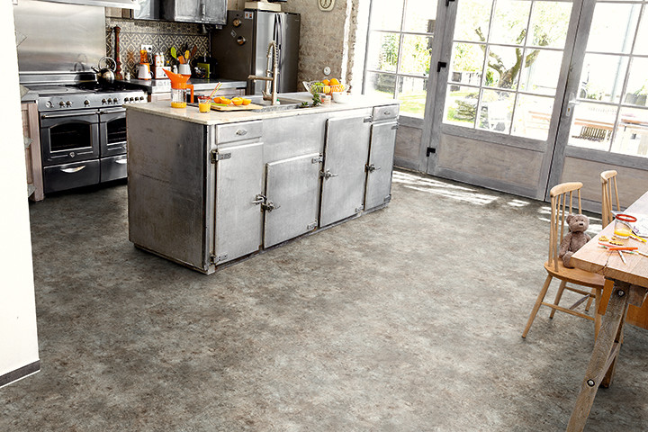 Inspiration for an industrial kitchen in Dresden with vinyl floors.