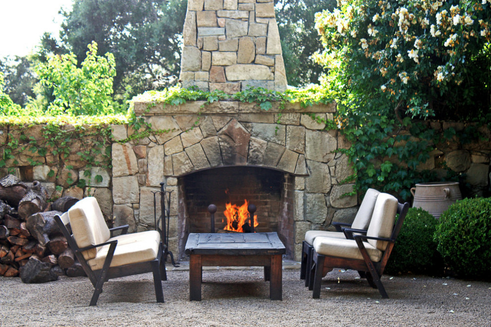 Design ideas for a french country drought-tolerant courtyard stone fence landscaping in Santa Barbara with a fireplace for fall.