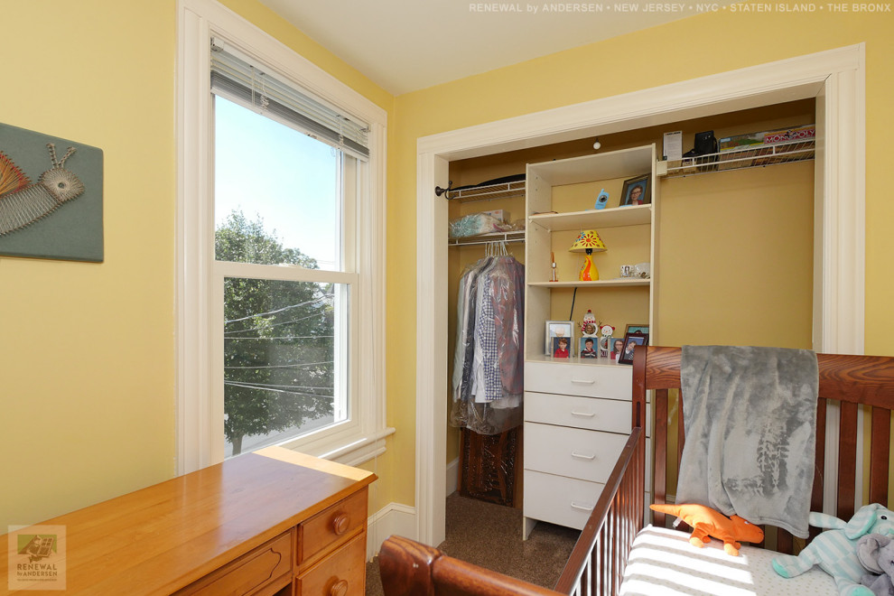 Kleines, Neutrales Babyzimmer mit gelber Wandfarbe, Teppichboden und braunem Boden in Newark