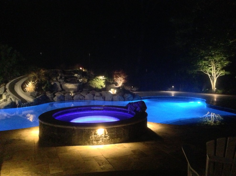 Inspiration for a mid-sized rustic backyard stone and kidney-shaped natural water slide remodel in Boston