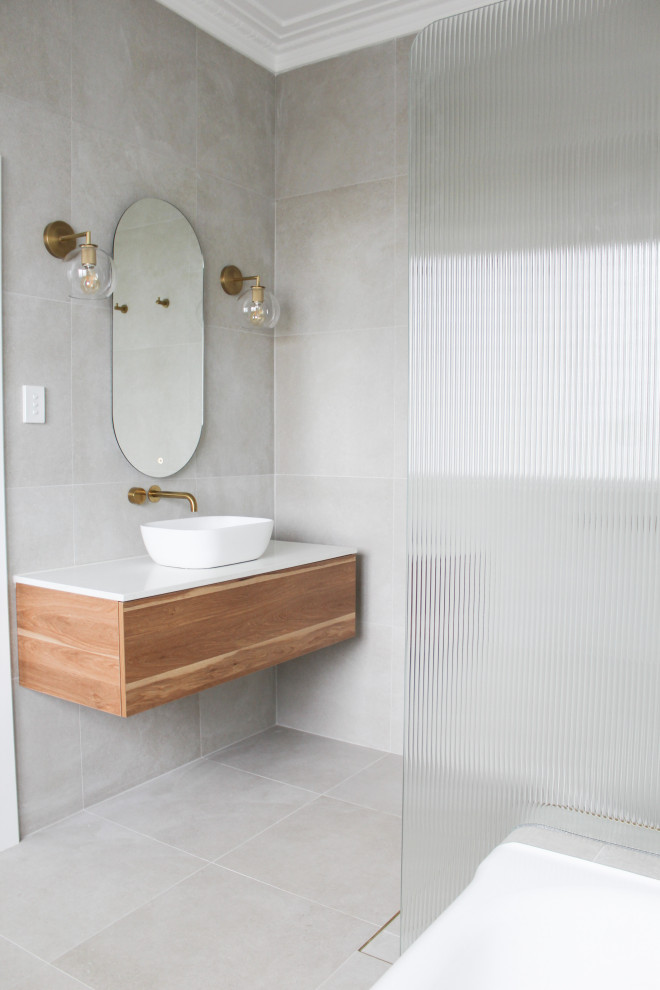 Large trendy master white tile and ceramic tile porcelain tile, gray floor and single-sink bathroom photo in Perth with flat-panel cabinets, dark wood cabinets, an undermount tub, a one-piece toilet, white walls, a vessel sink, quartz countertops, white countertops and a floating vanity
