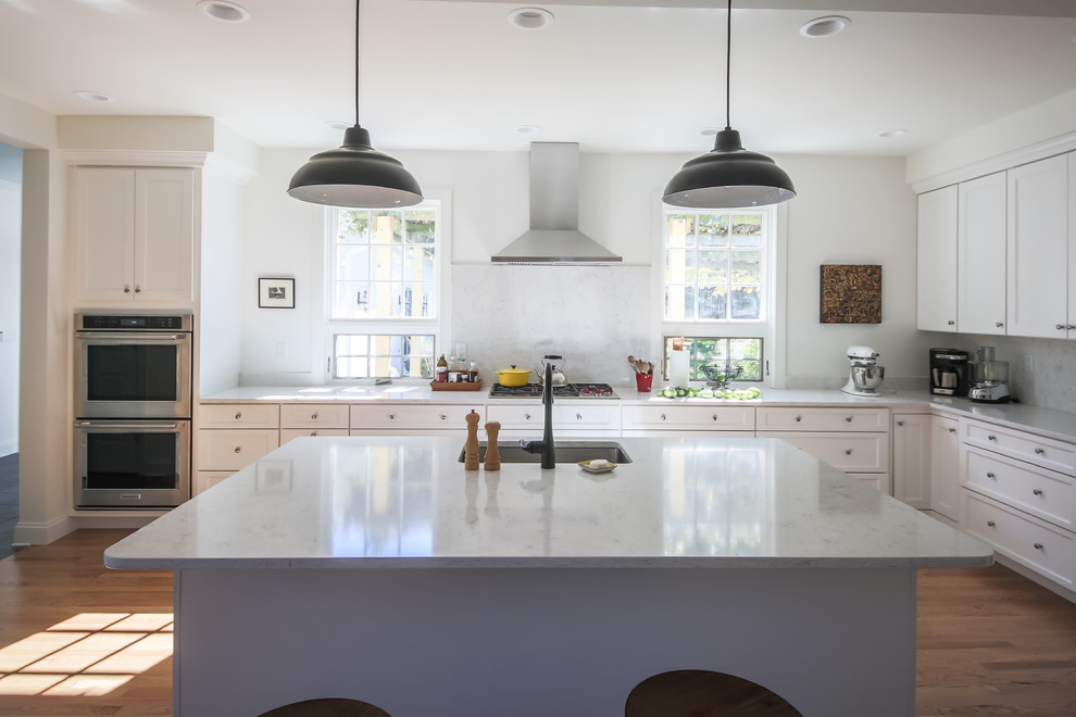 Inspiration for a large transitional l-shaped separate kitchen in Other with an undermount sink, recessed-panel cabinets, white cabinets, quartz benchtops, white splashback, stone slab splashback, stainless steel appliances, light hardwood floors, with island and yellow floor.