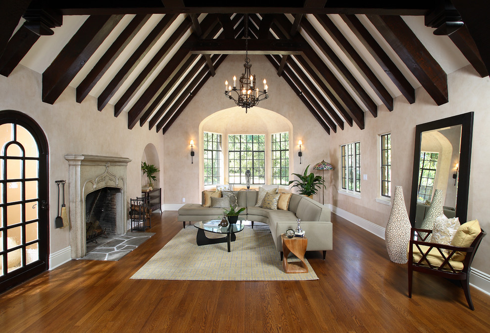 Large traditional formal enclosed living room in San Francisco with beige walls, medium hardwood floors, a standard fireplace and a plaster fireplace surround.