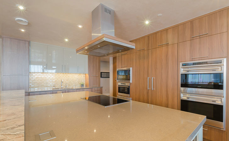Inspiration for a transitional kitchen remodel in Boston with an undermount sink, quartz countertops and an island