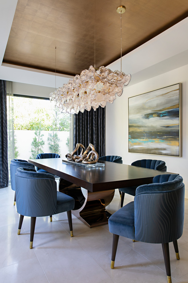 Contemporary dining room in Orange County with white walls, no fireplace and white floor.