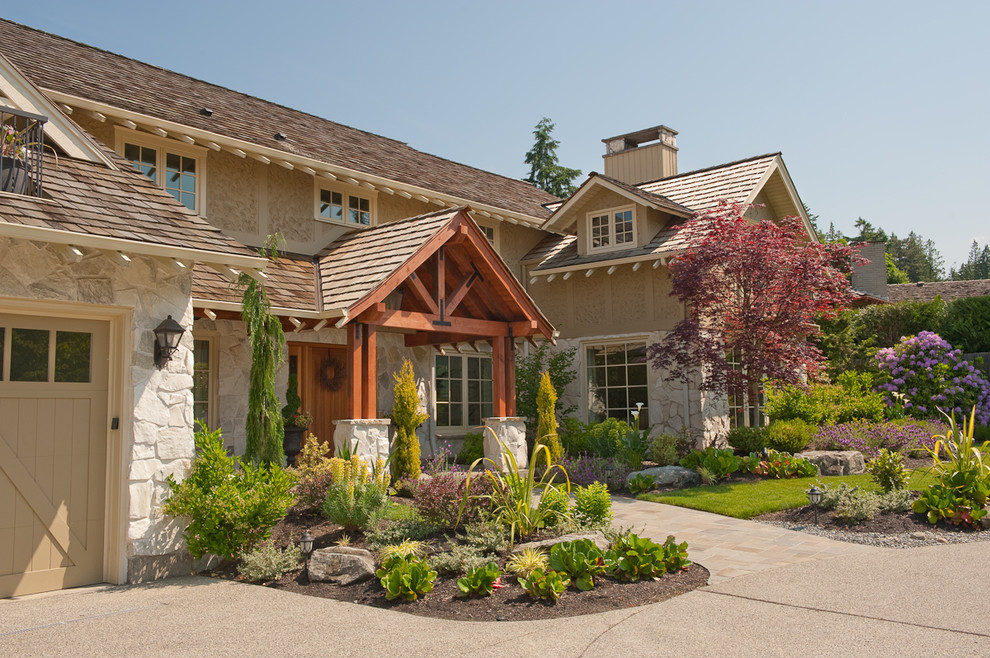 Design ideas for a traditional exterior in Seattle with stone veneer and a gable roof.