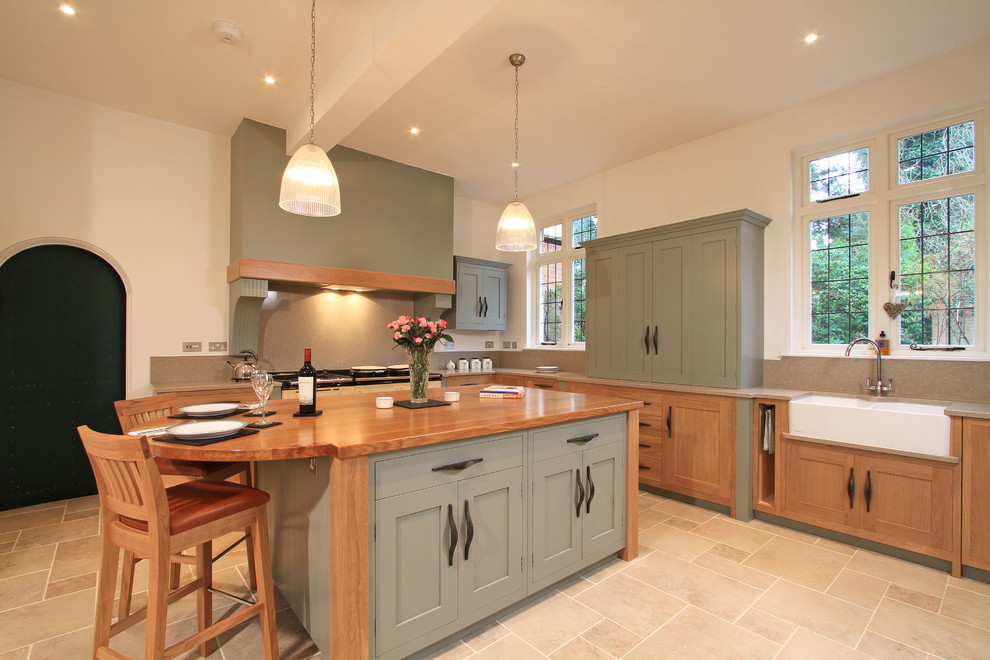 Design ideas for a transitional l-shaped eat-in kitchen in Hampshire with a double-bowl sink, shaker cabinets, green cabinets, quartz benchtops, stone slab splashback and beige splashback.