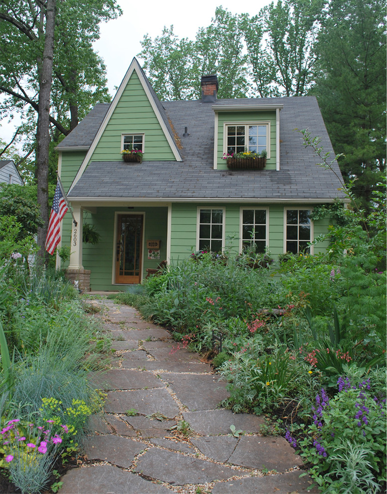 Photo of an arts and crafts two-storey green house exterior in Other with wood siding.
