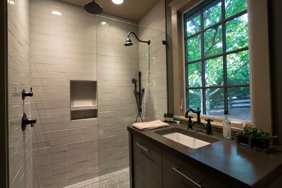 Mid-sized transitional 3/4 bathroom in Nashville with flat-panel cabinets, grey cabinets, gray tile, subway tile, concrete benchtops, an alcove shower, grey walls, mosaic tile floors, an undermount sink, multi-coloured floor and a hinged shower door.