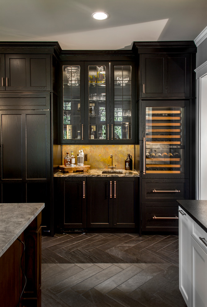 Design ideas for an expansive traditional home bar in Cincinnati with beaded inset cabinets, porcelain floors, an undermount sink, granite benchtops, multi-coloured splashback and black cabinets.