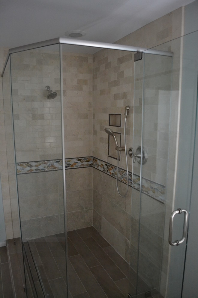This is an example of a transitional bathroom in Other with an undermount sink, raised-panel cabinets, white cabinets, granite benchtops, a corner shower, a two-piece toilet, brown tile and porcelain tile.