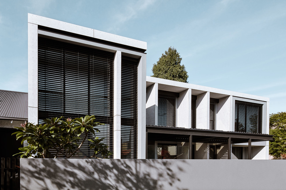 This is an example of an expansive contemporary two-storey concrete grey house exterior in Melbourne with a flat roof.
