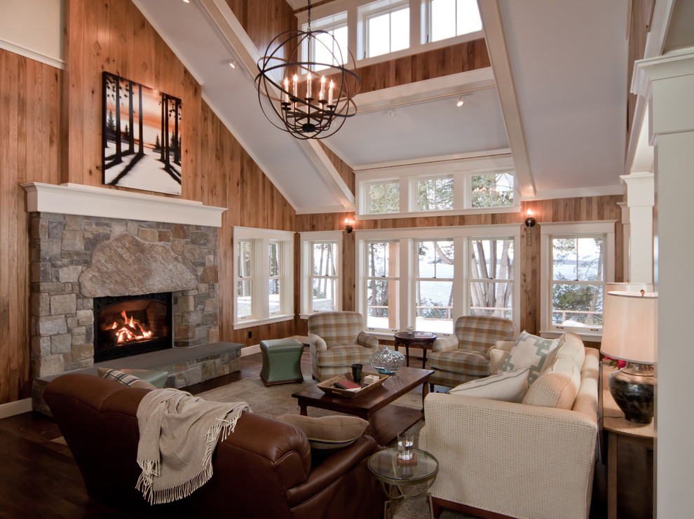 Photo of a large traditional open concept living room in Burlington with a standard fireplace, a stone fireplace surround, brown walls and dark hardwood floors.