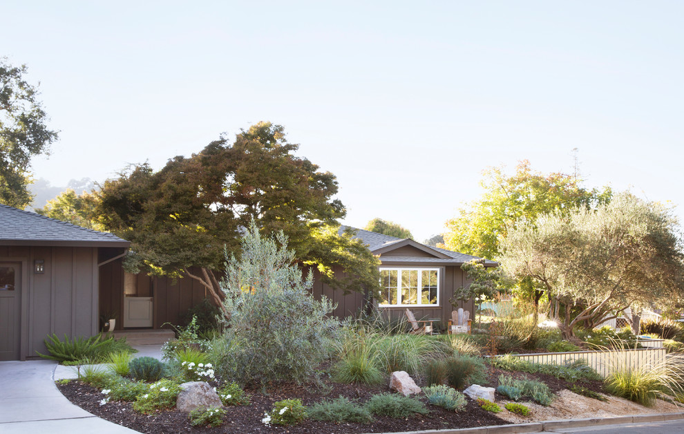 This is an example of a transitional front yard concrete paver formal garden.