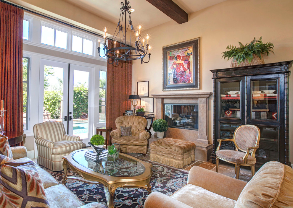 This is an example of an expansive traditional formal open concept living room in San Diego with beige walls, travertine floors, a standard fireplace, a plaster fireplace surround and no tv.