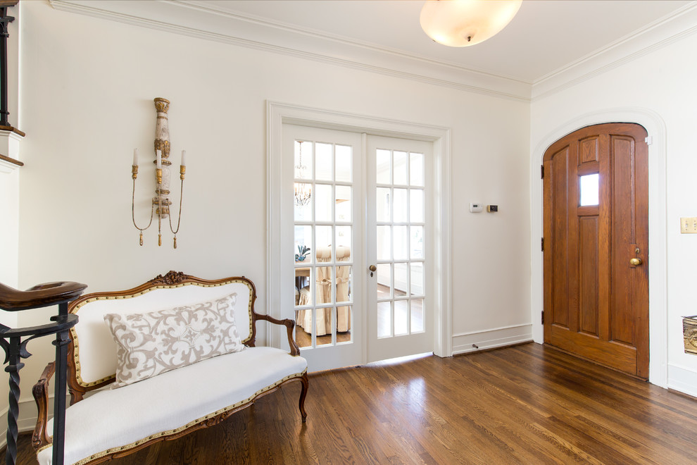 Mid-sized farmhouse light wood floor and brown floor entryway photo in Birmingham with white walls and a medium wood front door
