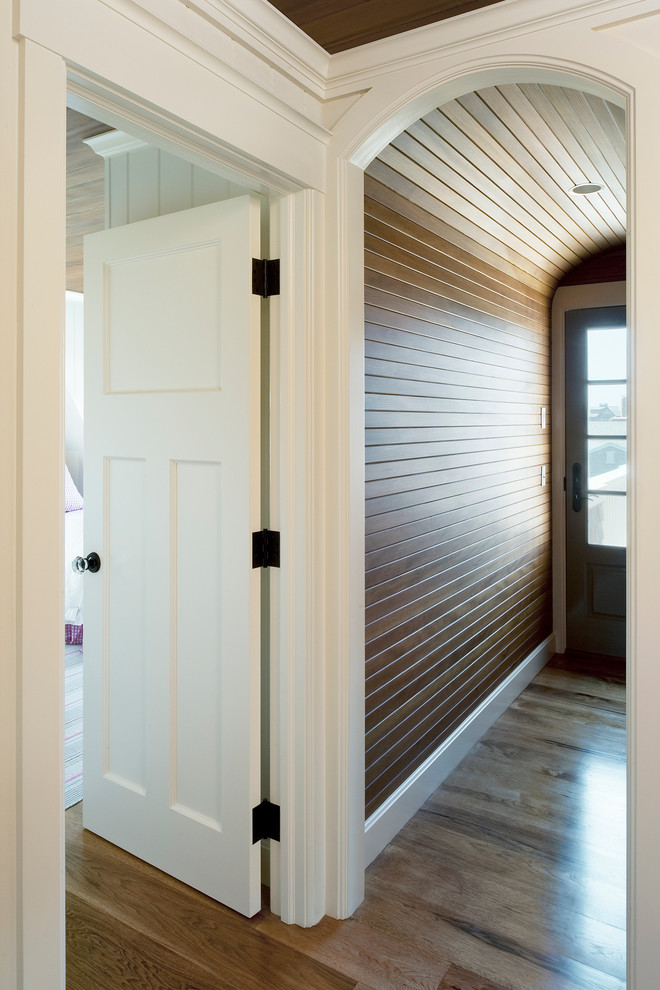 Mid-sized beach style hallway in Providence with dark hardwood floors and brown walls.