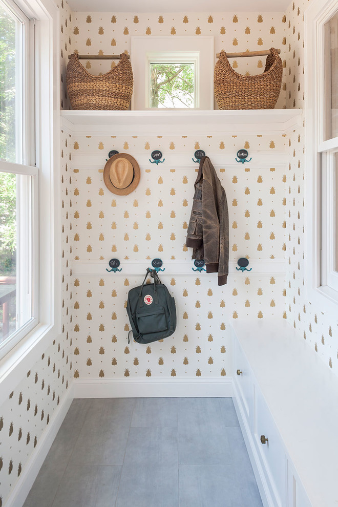 Transitional mudroom in New York with white walls.