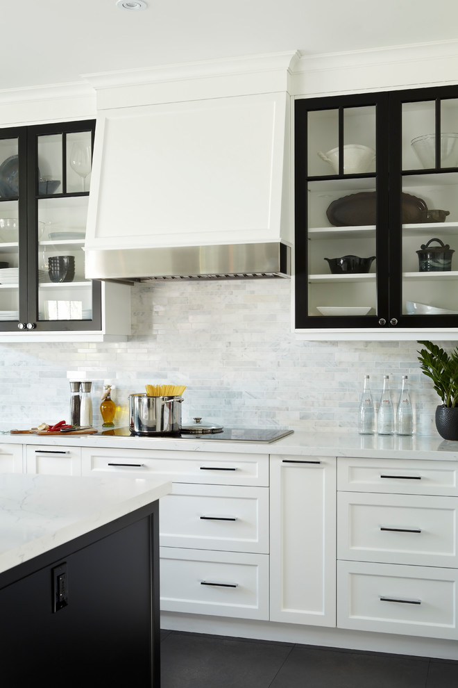 Design ideas for a transitional kitchen in Toronto with glass-front cabinets, black cabinets, grey splashback, dark hardwood floors, with island and black floor.