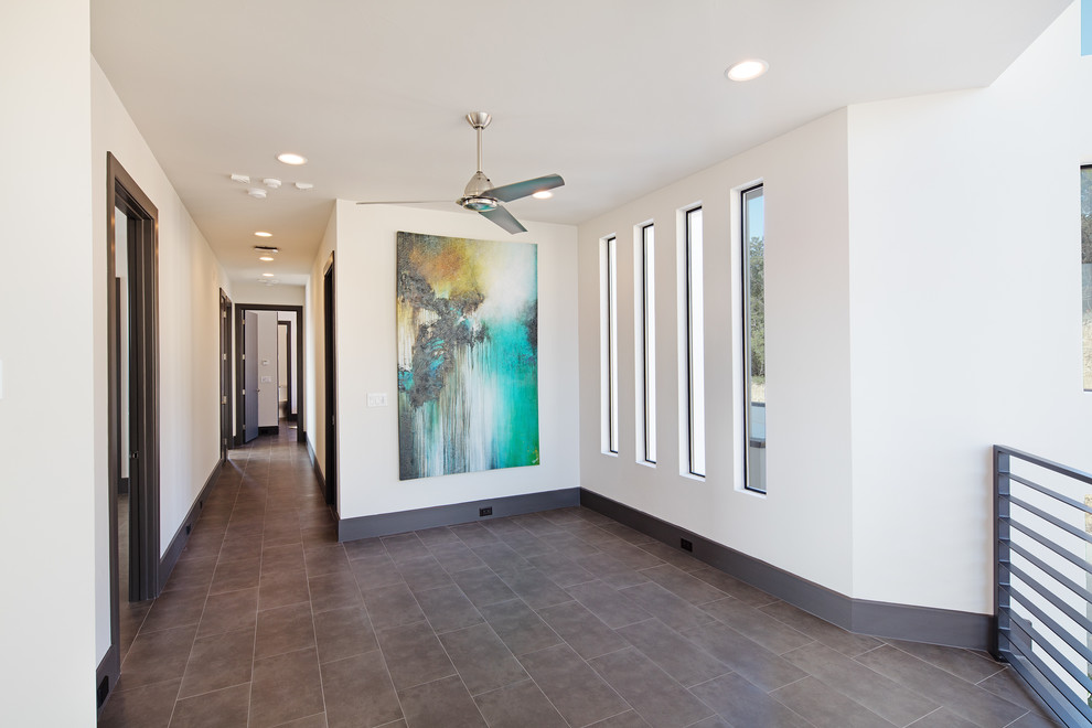 Inspiration for a mid-sized modern gender-neutral porcelain tile hallway remodel in Austin with white walls