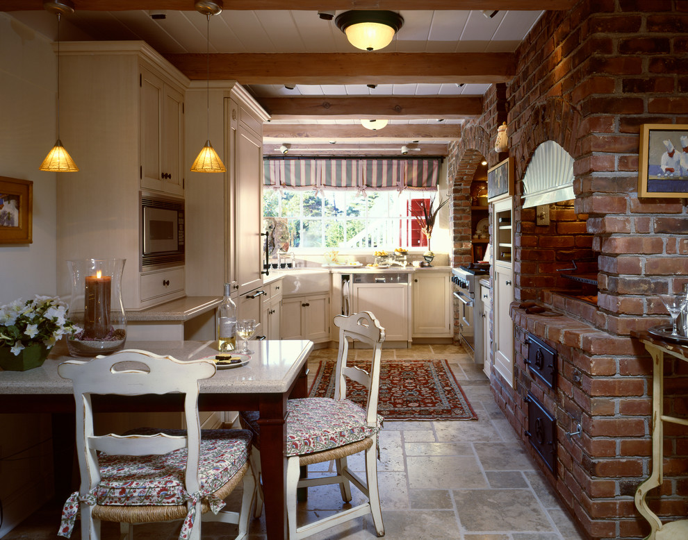 Enclosed kitchen - traditional u-shaped travertine floor enclosed kitchen idea in San Francisco with beige cabinets