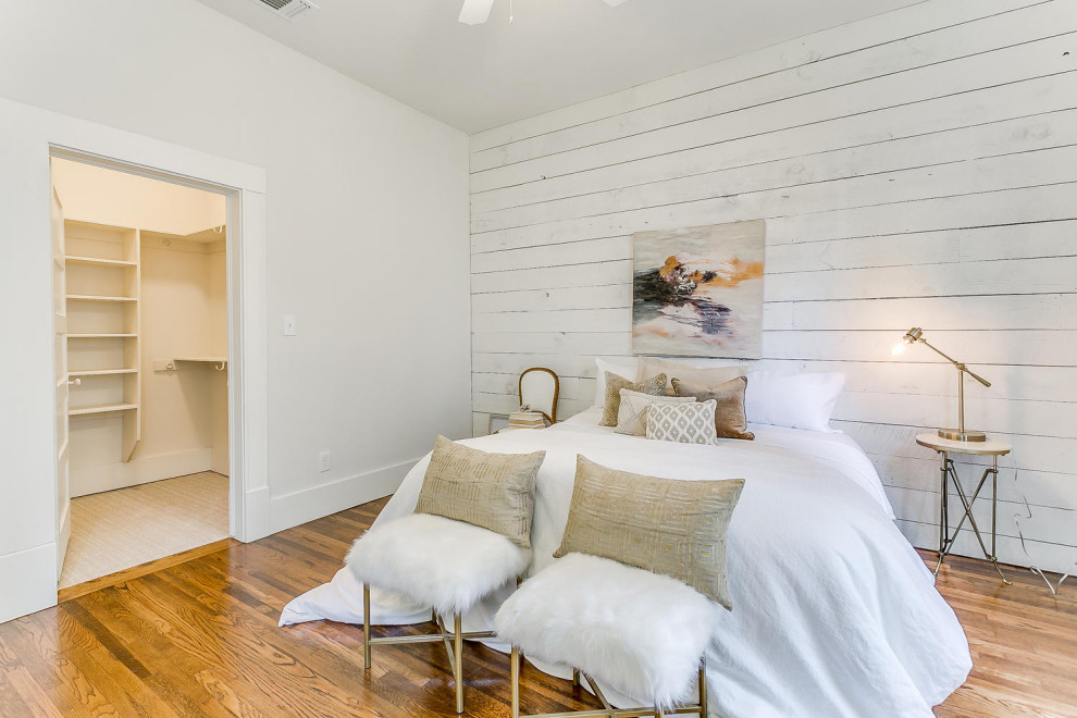 Large transitional master bedroom in Other with white walls, medium hardwood floors, no fireplace, brown floor, vaulted and planked wall panelling.