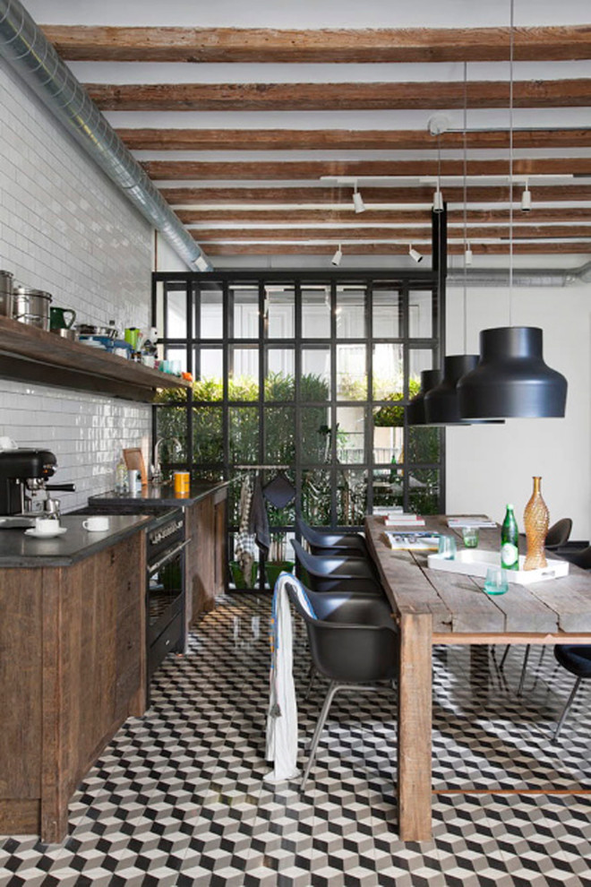 Design ideas for an industrial eat-in kitchen in Madrid with flat-panel cabinets, distressed cabinets, white splashback and subway tile splashback.