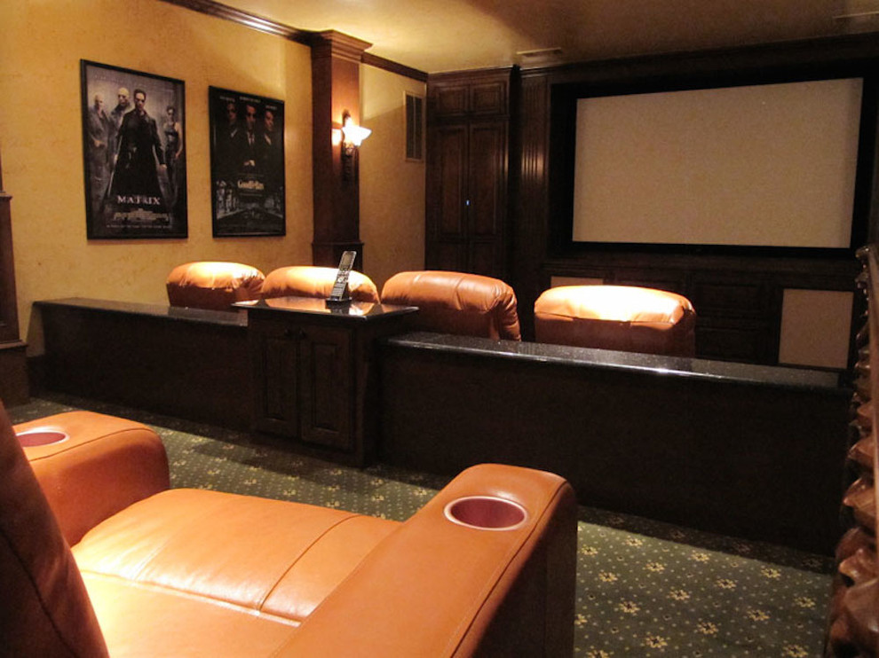 Photo of a mid-sized traditional enclosed home theatre in Dallas with brown walls, carpet, a projector screen and green floor.