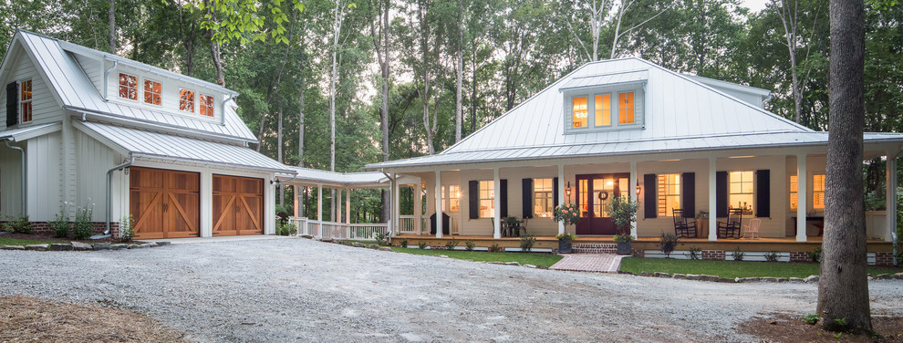 This is an example of a large country two-storey white house exterior in Atlanta with concrete fiberboard siding and a metal roof.