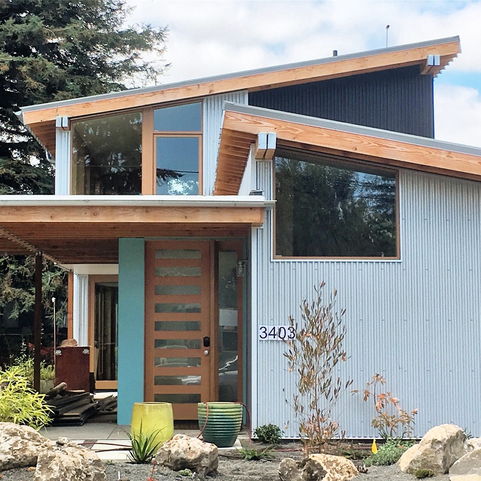 This is an example of a contemporary two-storey multi-coloured exterior in Portland with metal siding, a shed roof and a metal roof.