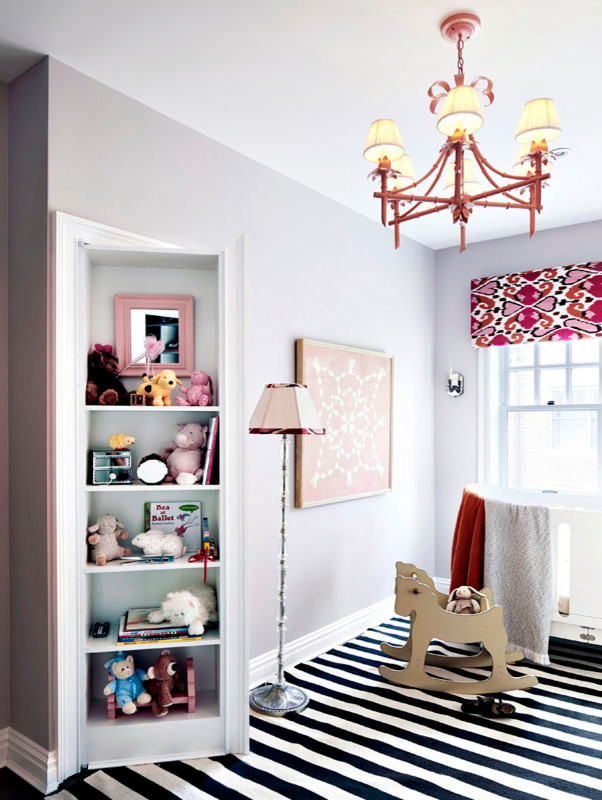 Photo of a mid-sized eclectic gender-neutral nursery in New York with grey walls and multi-coloured floor.