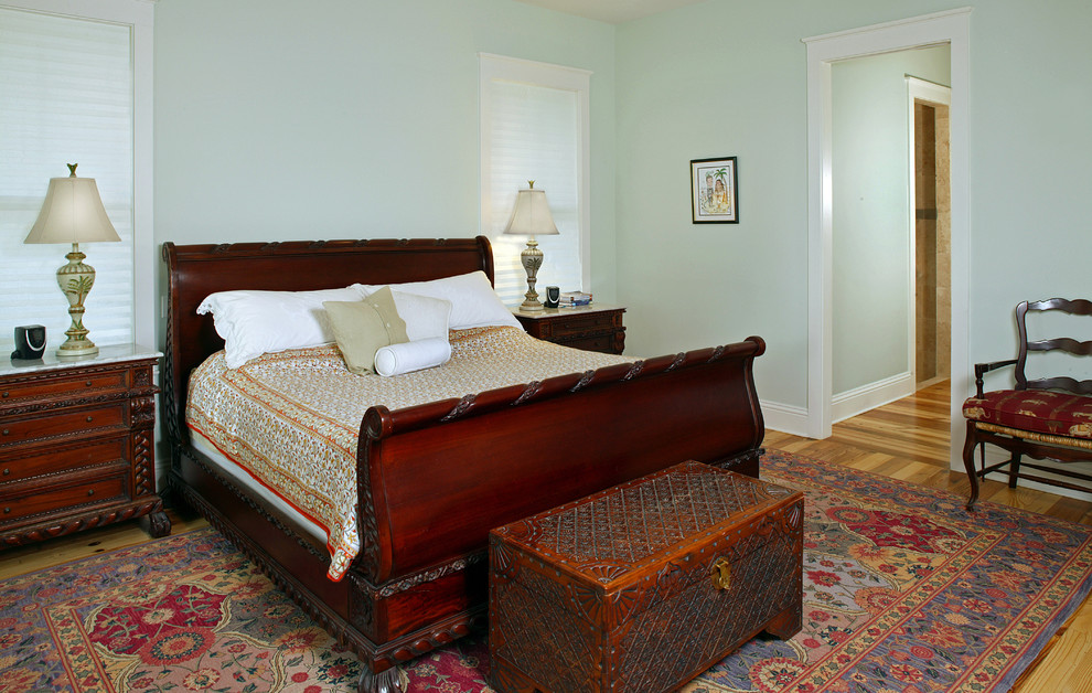 Inspiration for a traditional bedroom in Jacksonville with green walls and medium hardwood floors.