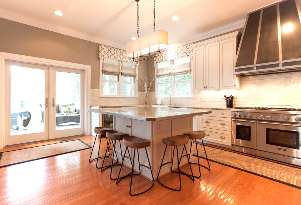 Kitchen - large transitional medium tone wood floor kitchen idea in DC Metro with an undermount sink, white cabinets, granite countertops, white backsplash, ceramic backsplash and stainless steel appliances