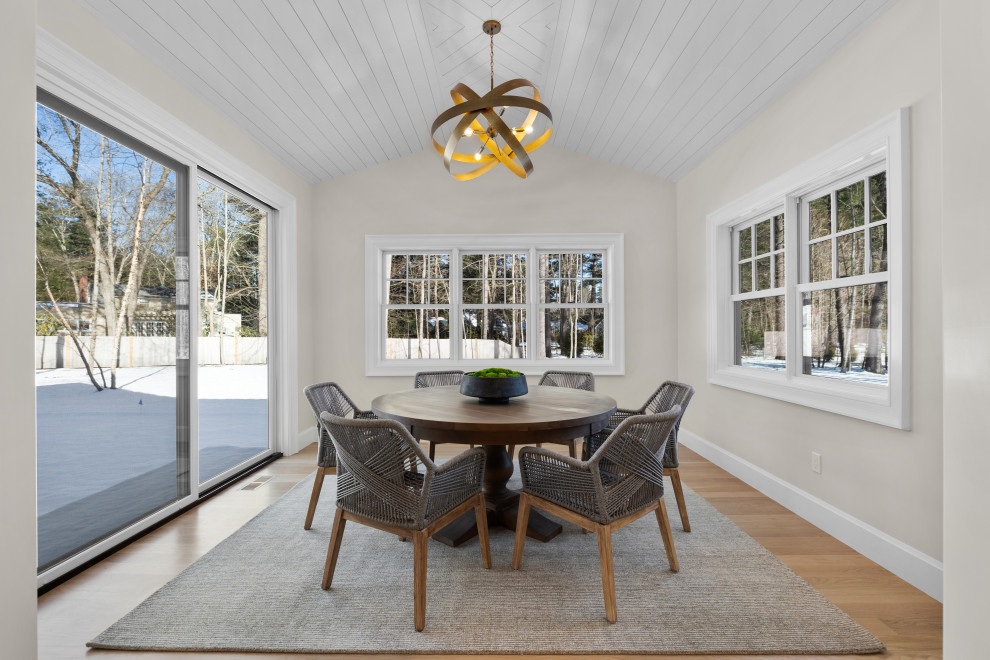 Example of a large transitional light wood floor, brown floor and shiplap ceiling open concept kitchen design in Boston with an undermount sink, shaker cabinets, white cabinets, quartz countertops, white backsplash, quartz backsplash, paneled appliances, an island and white countertops