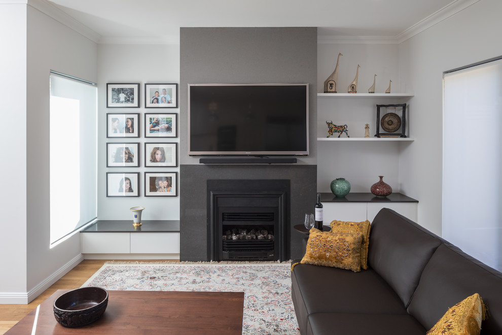 Inspiration for a modern living room in Perth with a standard fireplace, a stone fireplace surround and a wall-mounted tv.