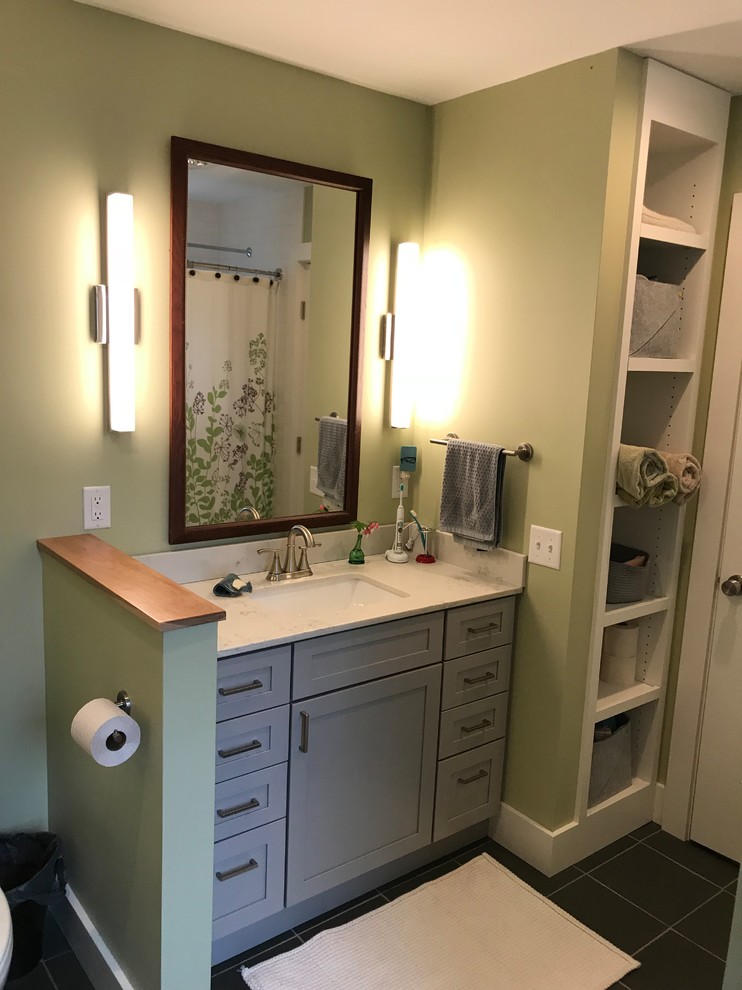 Photo of a mid-sized transitional master bathroom in Burlington with shaker cabinets, grey cabinets, a drop-in tub, a shower/bathtub combo, a two-piece toilet, green walls, slate floors, an undermount sink, marble benchtops, black floor, a shower curtain and white benchtops.