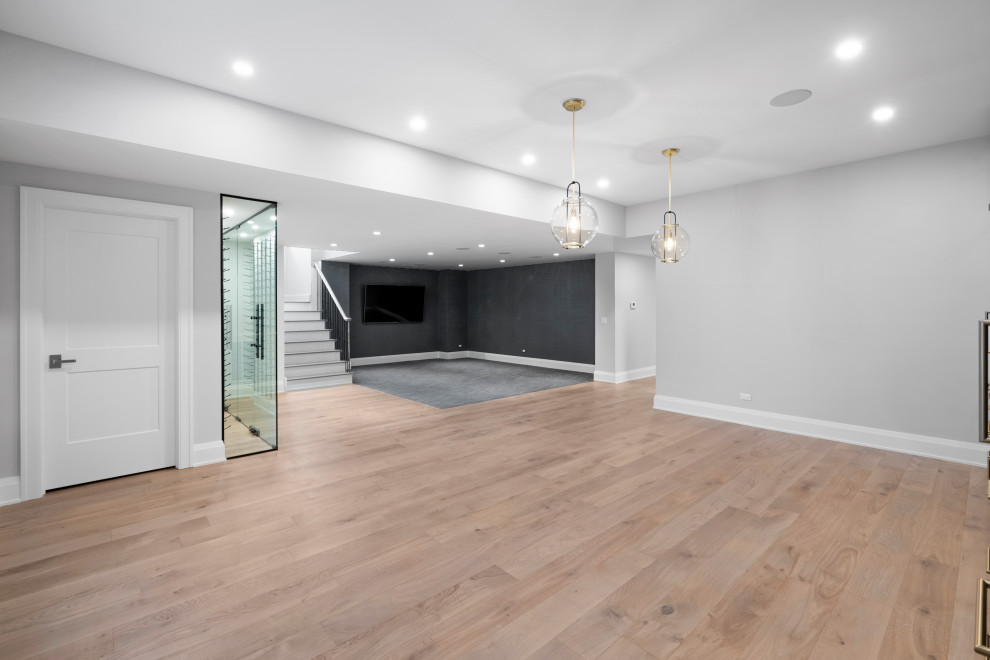 Basement - large transitional look-out light wood floor basement idea in Chicago with gray walls