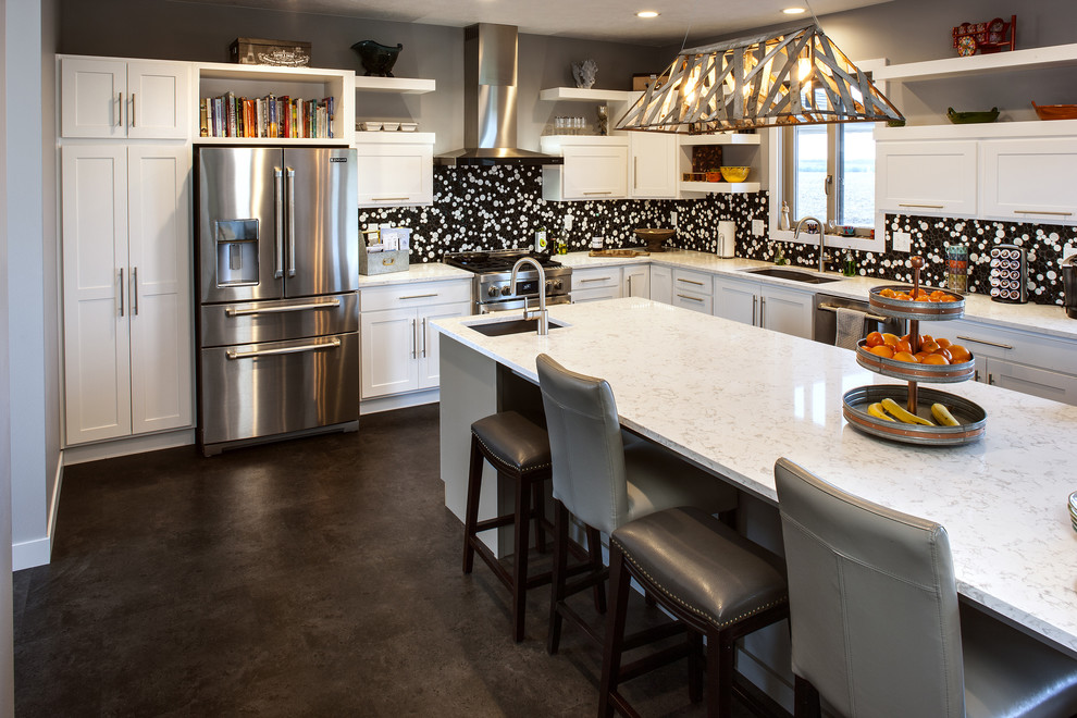 Photo of a l-shaped kitchen in Other with stainless steel appliances and an island.
