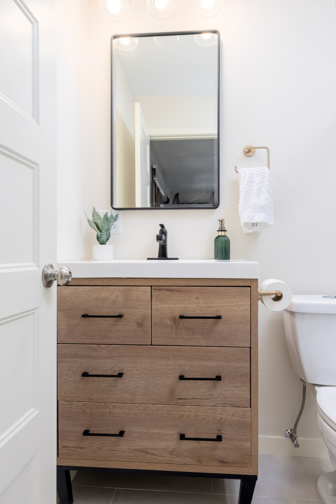 Example of a small transitional master multicolored tile and porcelain tile porcelain tile, beige floor and single-sink alcove shower design with flat-panel cabinets, medium tone wood cabinets, a two-piece toilet, white walls, an integrated sink, quartz countertops, white countertops, a niche and a freestanding vanity