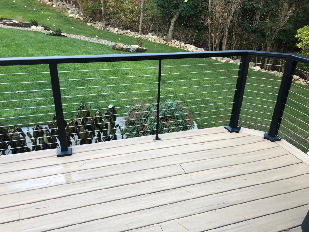 Design ideas for an arts and crafts backyard deck in Boston with metal railing.