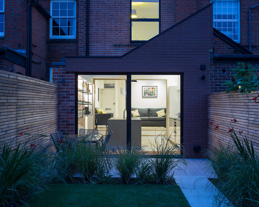 This is an example of a contemporary brick exterior in Berkshire with a shed roof.