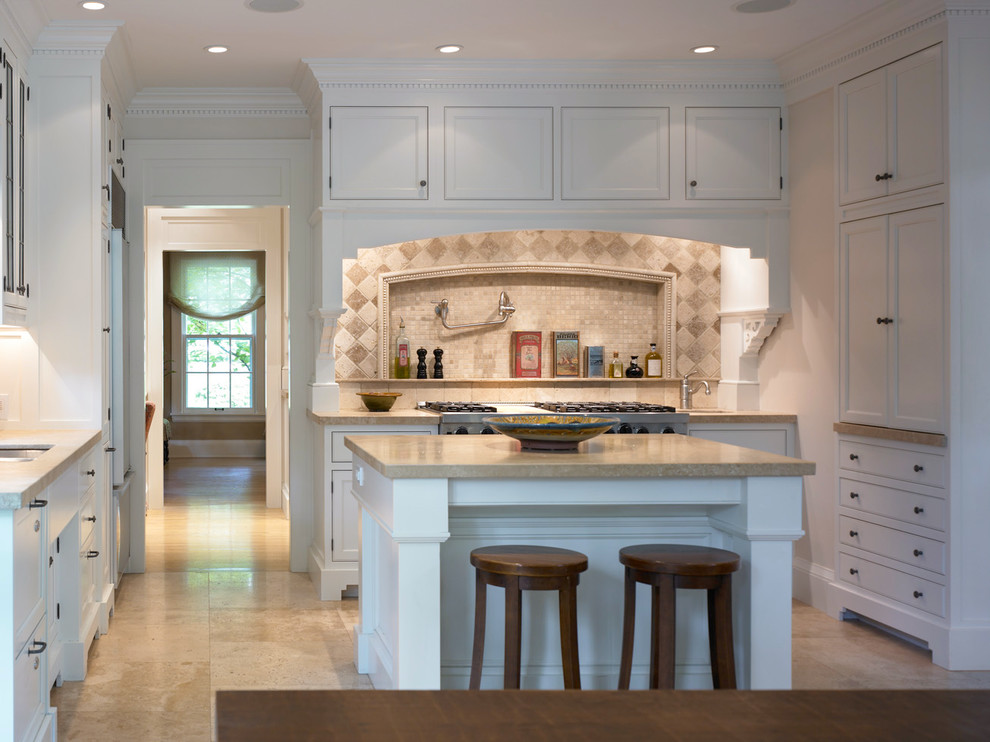 Large transitional u-shaped porcelain tile and multicolored floor enclosed kitchen photo with an undermount sink, shaker cabinets, white cabinets, quartzite countertops, beige backsplash, mosaic tile backsplash, stainless steel appliances and an island