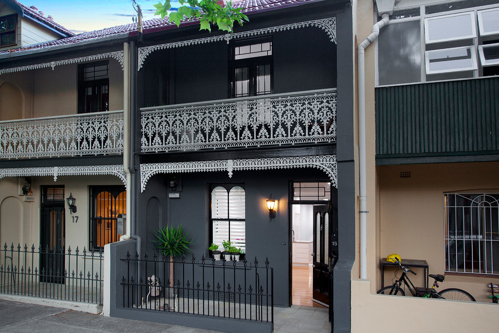 Design ideas for a traditional two-storey black house exterior in Sydney with a shed roof and a tile roof.