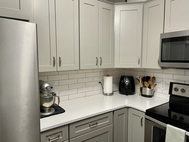 Example of a small transitional u-shaped enclosed kitchen design with shaker cabinets, gray cabinets and quartz countertops